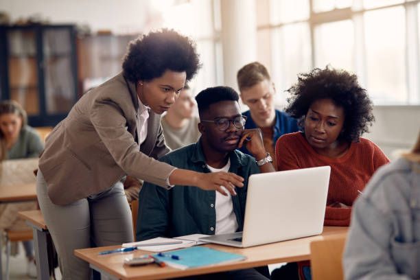 Education professionals reviewing opportunities on a laptop
